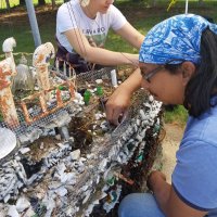 Restoration of the Grotto sculptures is ongoing.  Here conservators Ben Caguioa and Ruthie Rolfsmeyer repair the Bremen ocean liner sculpture.